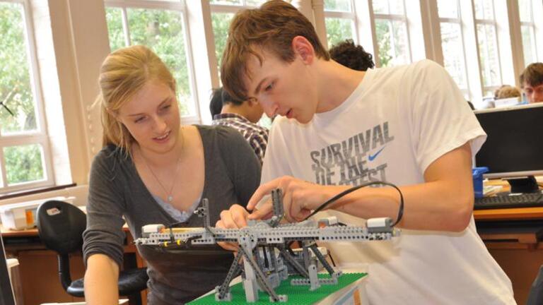 Students working on a LEGO MindStorms project using sensors.